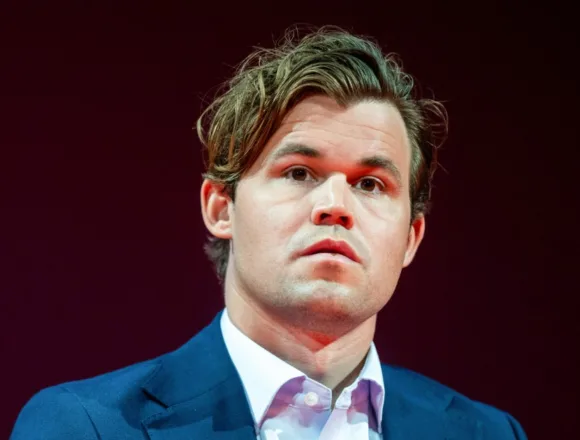 Chess champion returns to tournament after being fined for wearing jeans