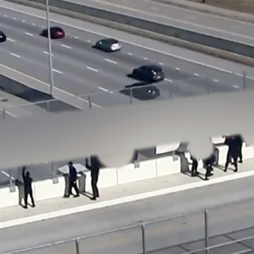 Demonstrators with Nazi flags leave Cincinnati-area highway overpass after residents confront them