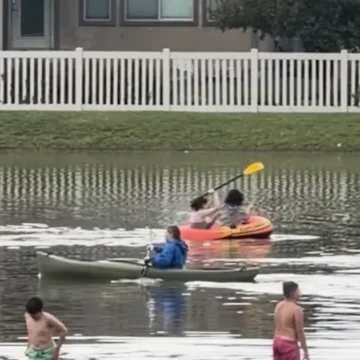 Several people canoe in flooded Utah streets