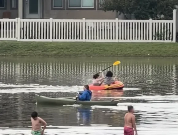 Several people canoe in flooded Utah streets