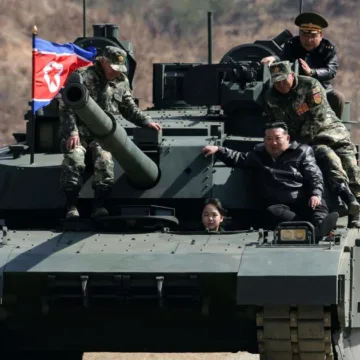 North Korean leader Kim and his daughter ride a tank together during army training