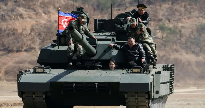 North Korean leader Kim and his daughter ride a tank together during army training