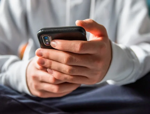 260120-teen-on-phone-gk-f32f4c.jpg Age verification is coming for the internet — and it’s already raising red flags