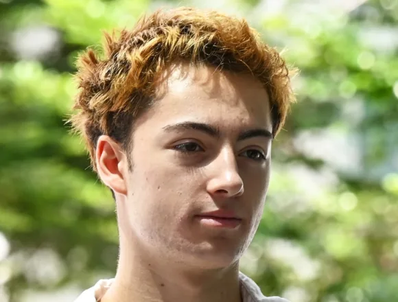 French teen charged in Singapore over a vending machine straw-licking video